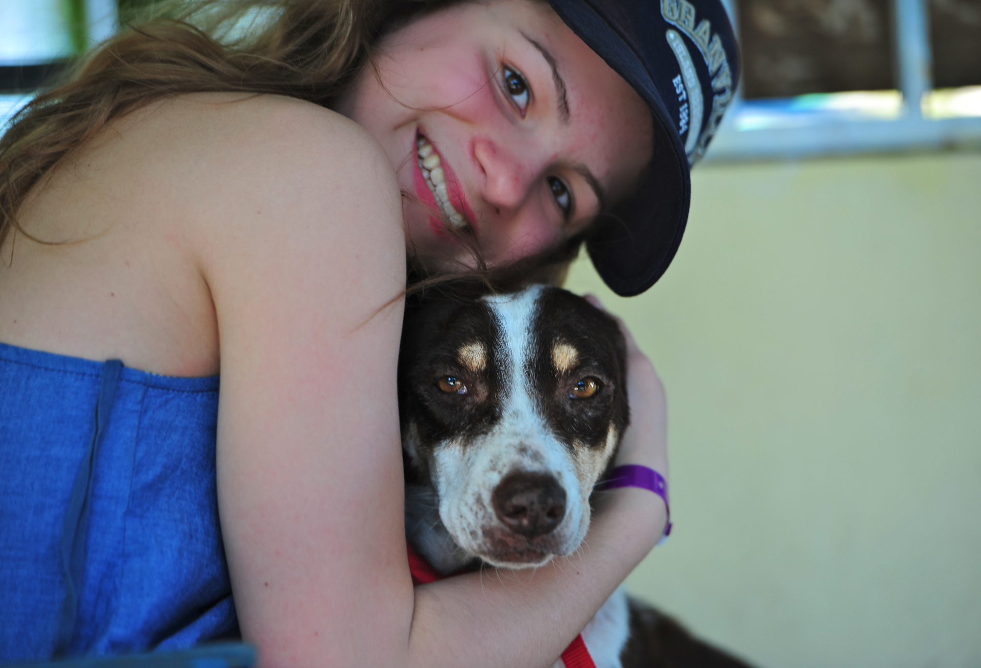 A person embracing a dog